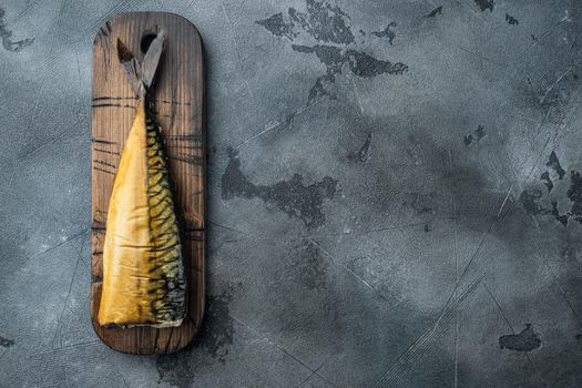 Smoked mackerel fish, on gray background, top view flat lay with copy space for text