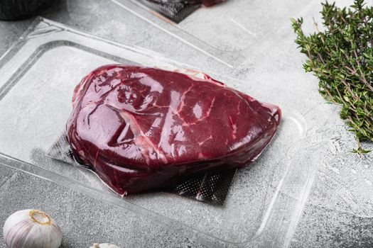 Pack with fresh rump beef steak set, on gray stone table background