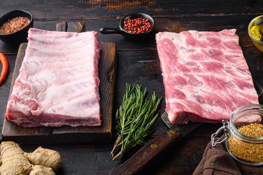 Fresh Pork ribs with a rosemary set, on old dark wooden table