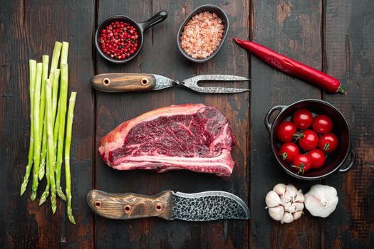 Raw fresh marbled meat black angus club steak and ingredients set, on old dark wooden table background, top view flat lay