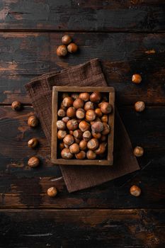 Organic Hazelnut whole nuts set, on old dark wooden table background, top view flat lay, with copy space for text