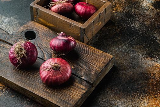 Red onion, on old dark rustic background with copy space for text