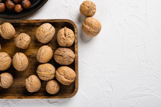 Natural walnut set, on white stone table background, top view flat lay, with copy space for text