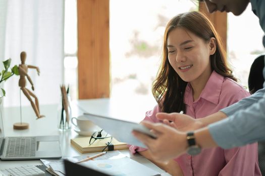 Business asian adviser analyzing financial figures denoting the progress in the work of the company, Two business partnership coworkers discussing a financial planning concept.