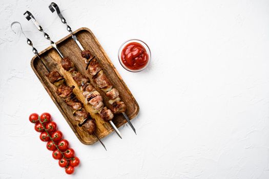 Grilled meat skewers, shish kebab with onion set, on white stone table background, top view flat lay, with copy space for text