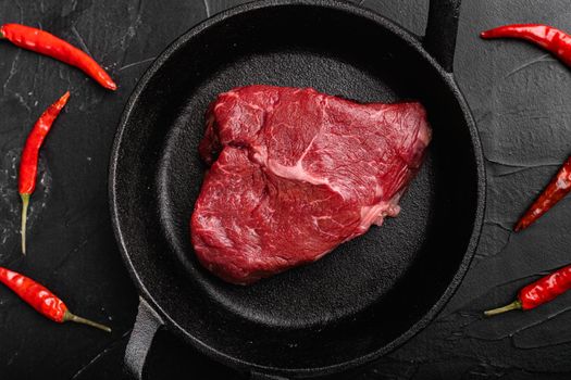 Raw cap rump steak set, on black dark stone table background, top view flat lay