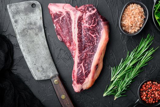 Raw beef steak set,T bone cut, on black stone background, top view flat lay