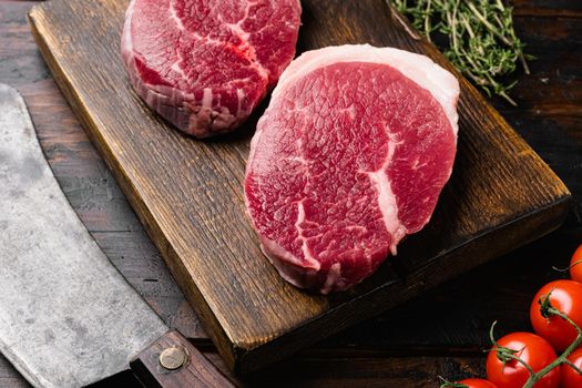 Fresh raw organic beef steak set, on old dark wooden table background