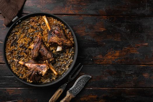 Baked whole lamb shanks meat set, on old dark wooden table background, top view flat lay, with copy space for text