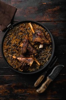 Baked lamb shank meat set, on old dark wooden table background, top view flat lay