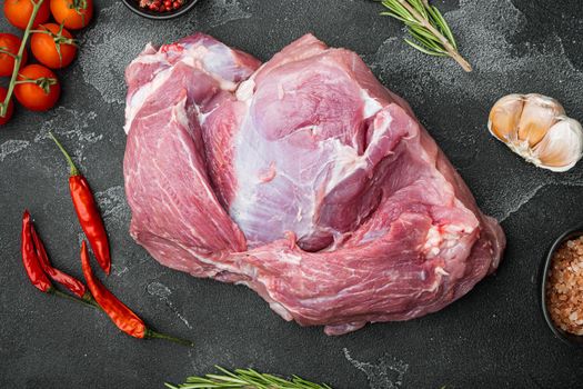 Raw slice of Iberian pork with ingredients set, on black dark stone table background, top view flat lay