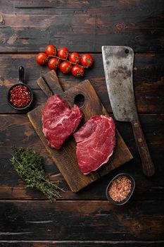 Beef raw rump steak with salt pepper rosemary set, on old dark wooden table background, top view flat lay
