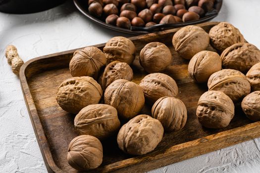 Walnut whole nut set, on white stone table background