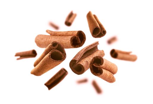 Cinnamon sticks levitate on a white background.