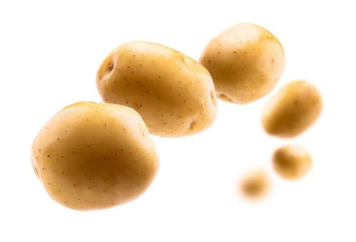 Golden potatoes levitate on a white background.