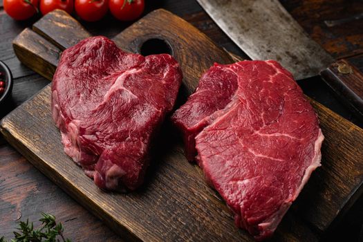 Raw seasoned rump steaks beef meat set, on old dark wooden table background