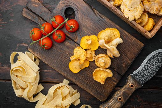 Pasta chanterelle mushrooms ingredients set, on old dark wooden table background, top view flat lay