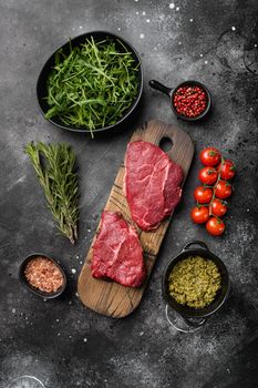 Fresh raw Beef meat Rump Steak set, on black dark stone table background, top view flat lay