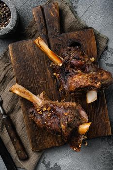 Baked whole lamb shanks meat set, on gray stone table background, top view flat lay
