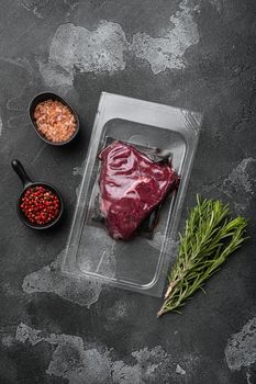 Beef rump steak pack set, on black dark stone table background, top view flat lay