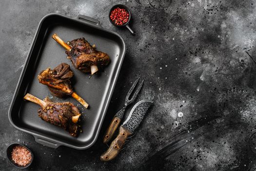 Stew Lamb meat Shanks set, on black dark stone table background, top view flat lay, with copy space for text