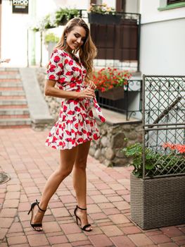 picture of beautiuful caucasaian female model with pretty face in short dress and high heel shoes rejoicing