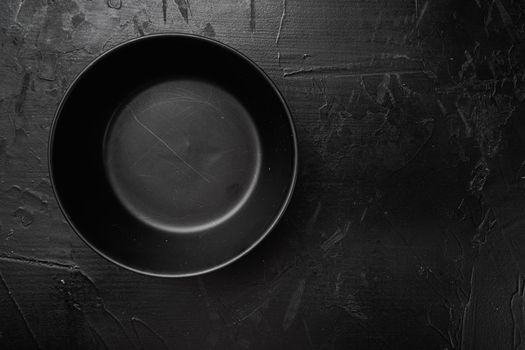 Empty black bowl set, with copy space for text or food, with copy space for text or food, top view flat lay, on black dark stone table background