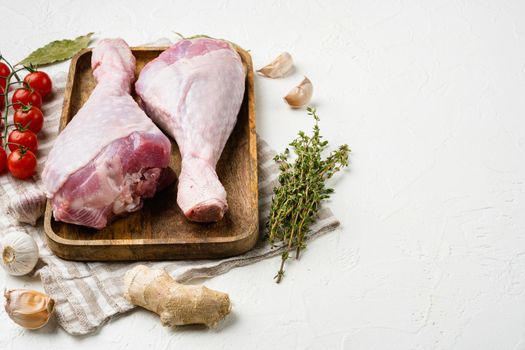 Turkey drumstick fresh meat set, on white stone table background, with copy space for text