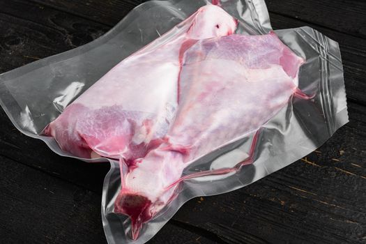 Poultry vacuum packed pack set, on black wooden table background