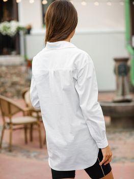 pretty caucasian female with brown hair in street style clothes outdoor