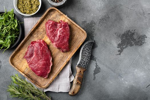 Beef rump meat steak set, on gray stone table background, top view flat lay, with copy space for text