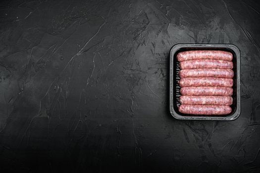 Flesh meat product for cooking packed in box set, on black dark stone table background, top view flat lay, with copy space for text