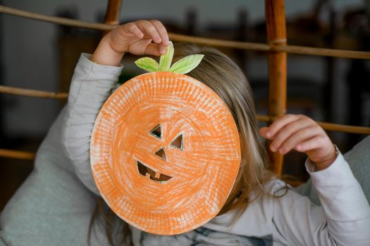 Children making Halloween decorations colored paper