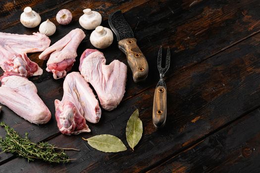 Fresh raw duck wings set, on old dark wooden table background, with copy space for text