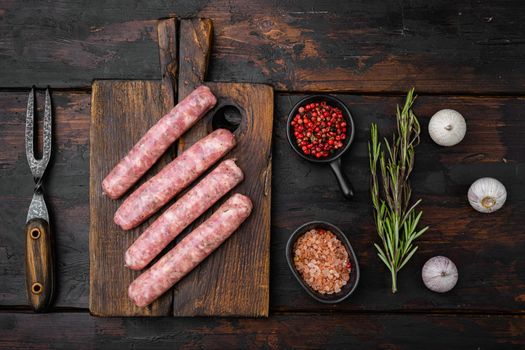 Minced meat sausages set, on old dark wooden table background, top view flat lay