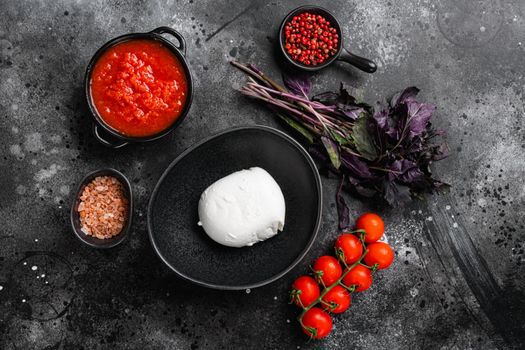 Buffalo mozzarella set, on black dark stone table background, top view flat lay, with copy space for text