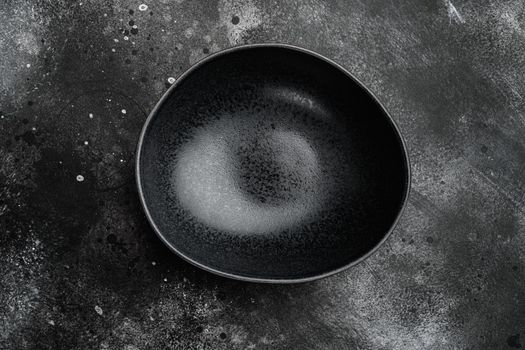 Empty black bowl set, with copy space for text or food, with copy space for text or food, top view flat lay, on black dark stone table background