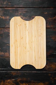 Used bamboo chopping board empty for empty for copy space for text or food, top view flat lay, on old dark wooden table background