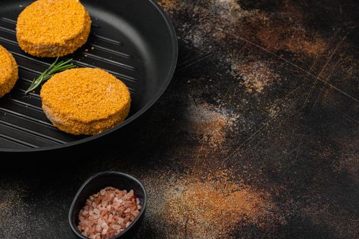 Raw fishcake Breaded set, on old dark rustic table background, with copy space for text