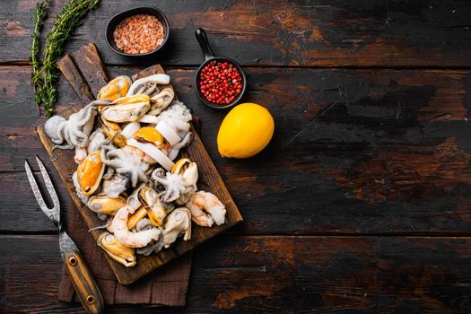 Fresh seafood arrangement mussels, squid octopus set, on old dark wooden table background, top view flat lay, with copy space for text