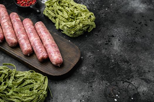 Easy sausage carbonara ingredients set, on black dark stone table background, with copy space for text