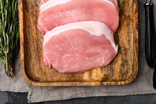 Pork meat. Fresh pork steaks set, on gray stone table background, top view flat lay