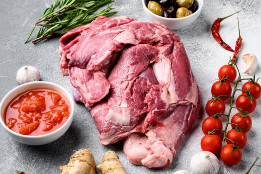 Mutton or lamb Fresh raw meat set, with ingredients and herbs, on gray stone table background