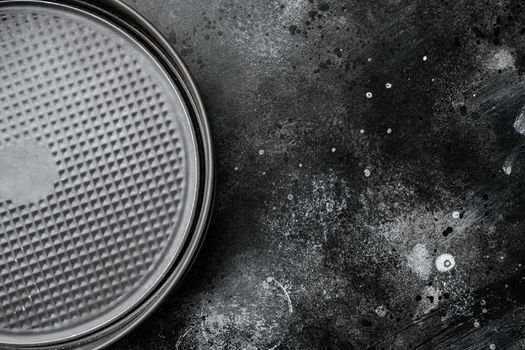 Metal empty Baking tray set, with copy space for text or food, with copy space for text or food, top view flat lay, on black dark stone table background