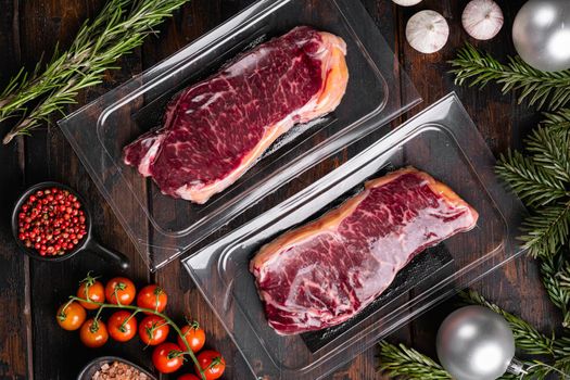 Beef marbled meat steak pack to the Christmas and New Year set, on old dark wooden table background, top view flat lay