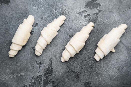 Raw croissant dough set, on gray stone table background, top view flat lay
