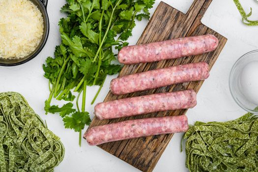 Uncooked Pasta sausage carbonara ingredients set, on white stone table background, top view flat lay