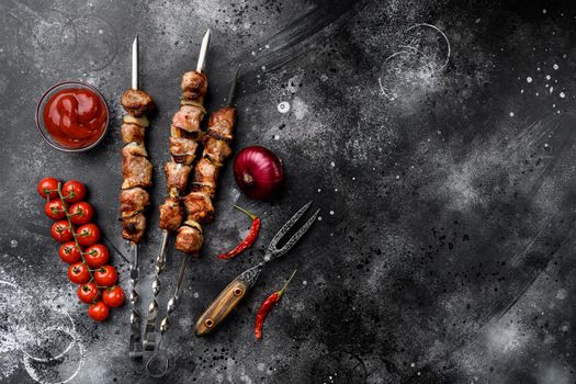 Grilled kebab set, on black dark stone table background, top view flat lay, with copy space for text