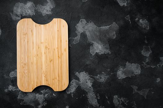 Empty vintage cutting board set, on black dark stone table background, top view flat lay , with copy space for text or your product