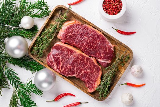 New-York steak with a Christmas tree set, on white stone table background, top view flat lay, with copy space for text